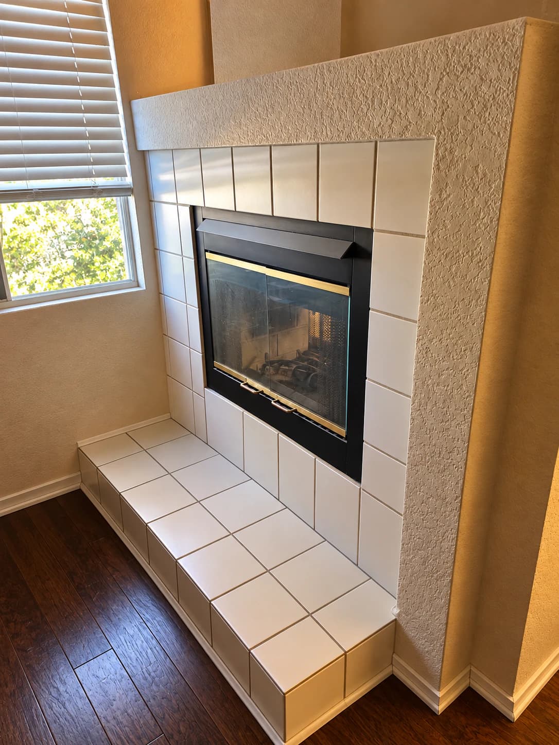 Original fireplace surround finished with plain white square tile